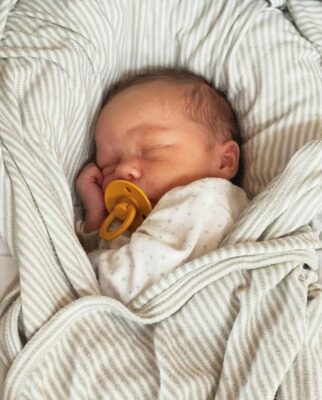 baby sleeping under blanket